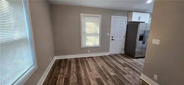 a view of a room with wooden floor and window