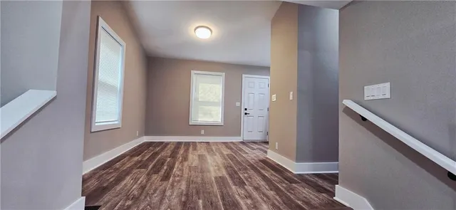 a view of a room with wooden floor and window