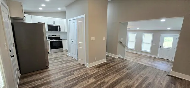 a view of a refrigerator in kitchen and wooden floor