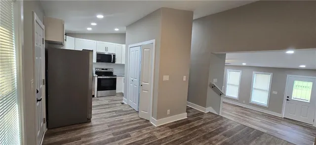 a view of a refrigerator in kitchen and wooden floor