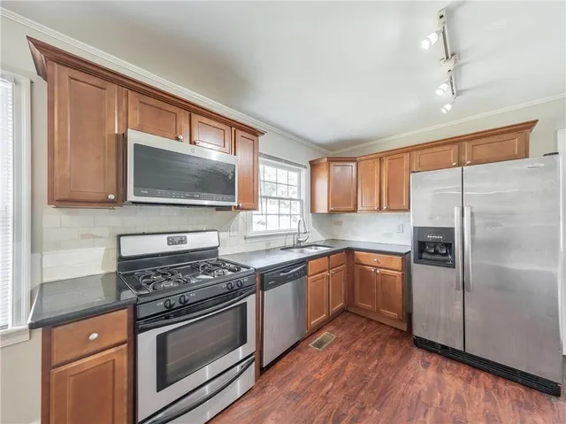 a kitchen with wooden floors and a stove