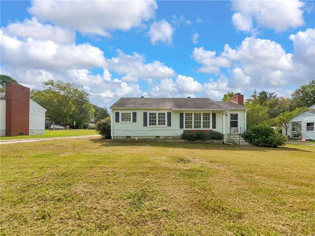 a front view of house with yard and swimming pool