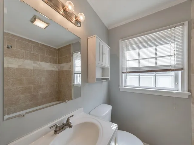 a bathroom with a bathtub a window and a shower