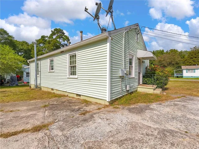 a kitchen with granite countertop a stove top oven sink and cabinets