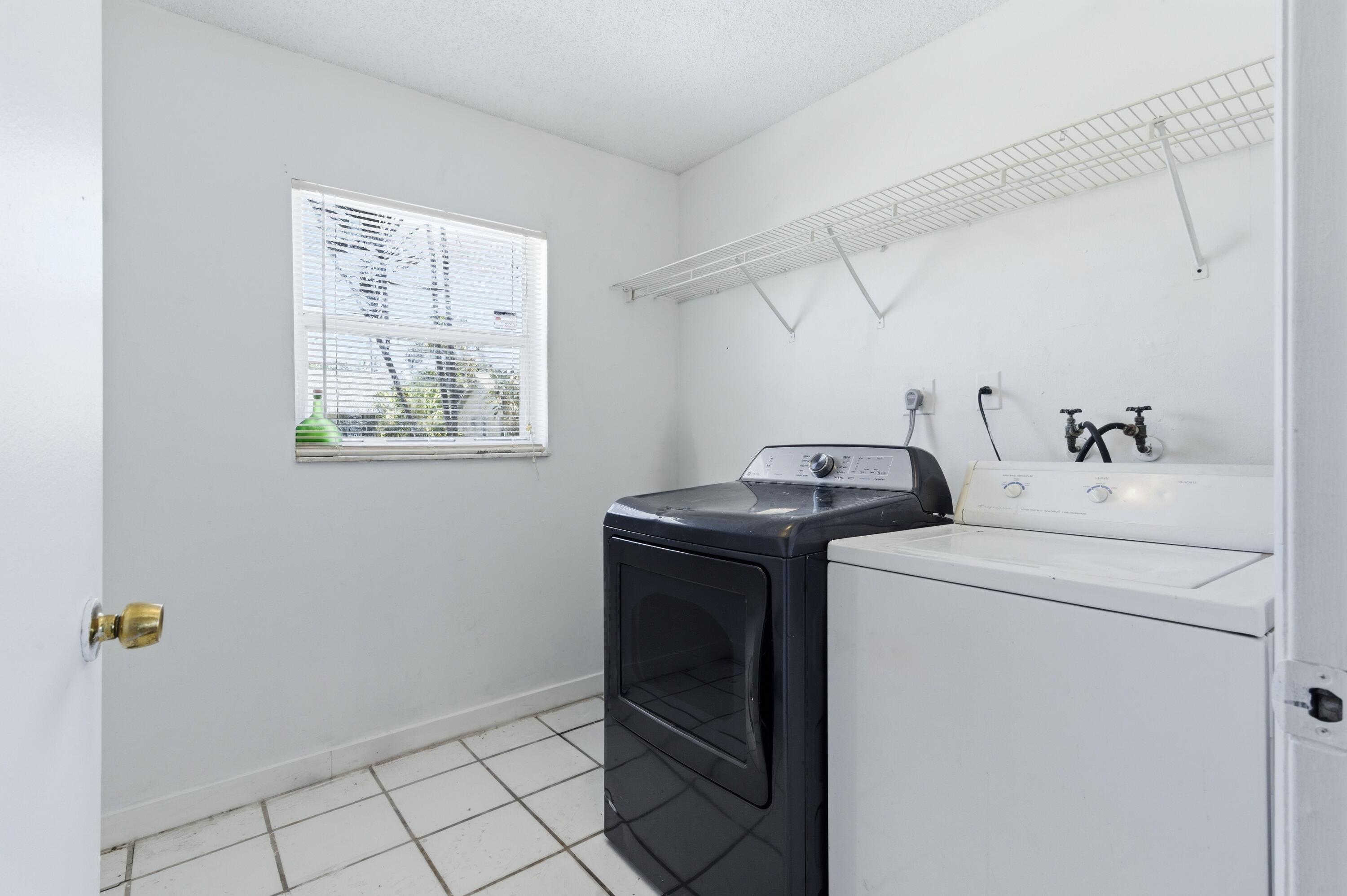 6088 Heather Street Jupiter, FL 33458 - Photo 9 of 18 a utility room with dryer and washer