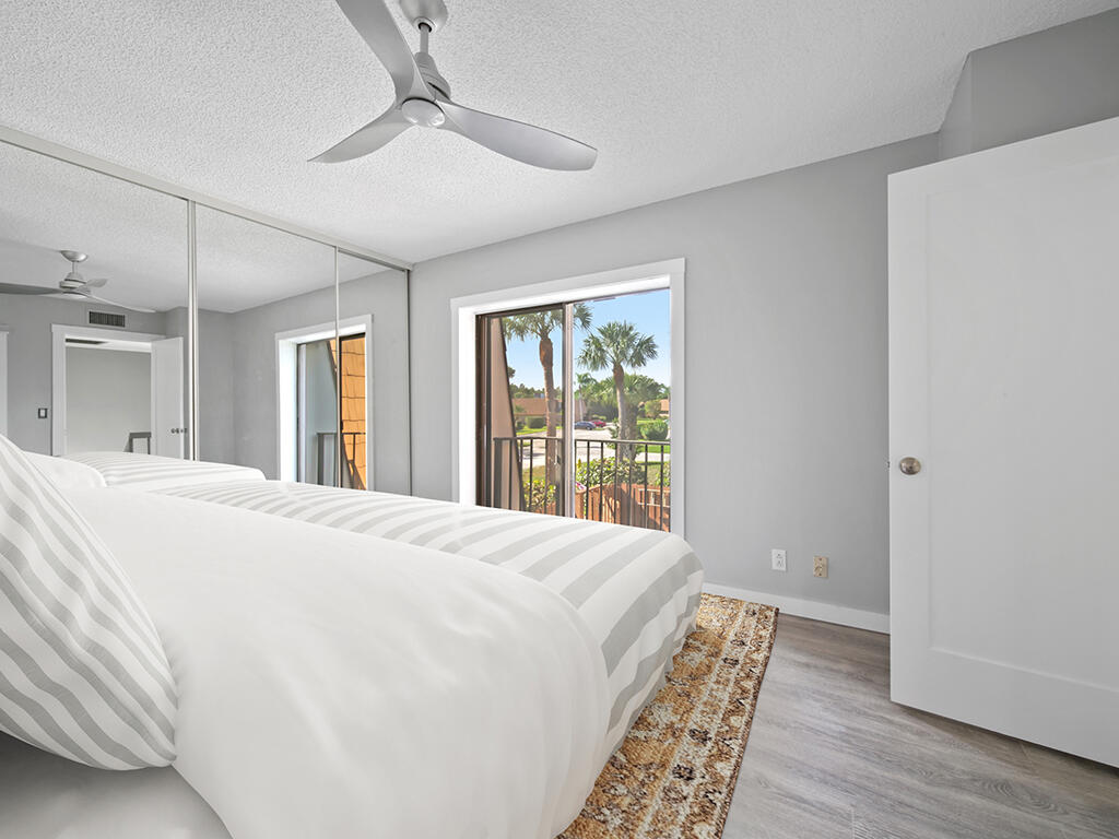5992 Southeast Riverboat Drive, Unit 537 Stuart, FL 34997 - Photo 13 of 14 a spacious bedroom with a large bed and a window