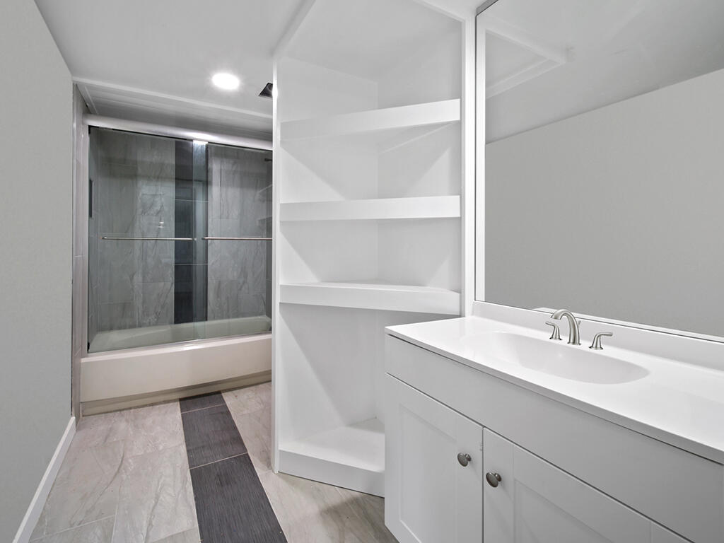 5992 Southeast Riverboat Drive, Unit 537 Stuart, FL 34997 - Photo 14 of 14 a bathroom with a sink and a mirror