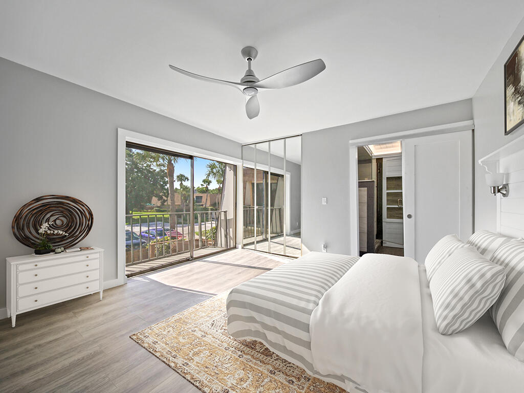 5992 Southeast Riverboat Drive, Unit 537 Stuart, FL 34997 - Photo 8 of 14 a bedroom with a large bed and a large window