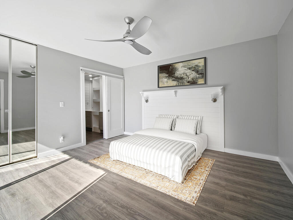 5992 Southeast Riverboat Drive, Unit 537 Stuart, FL 34997 - Photo 9 of 14 a spacious bedroom with a bed and a shower