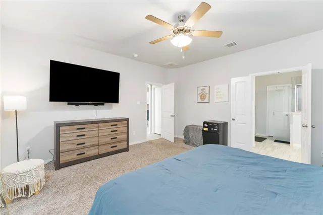 a bedroom with furniture and a flat screen tv