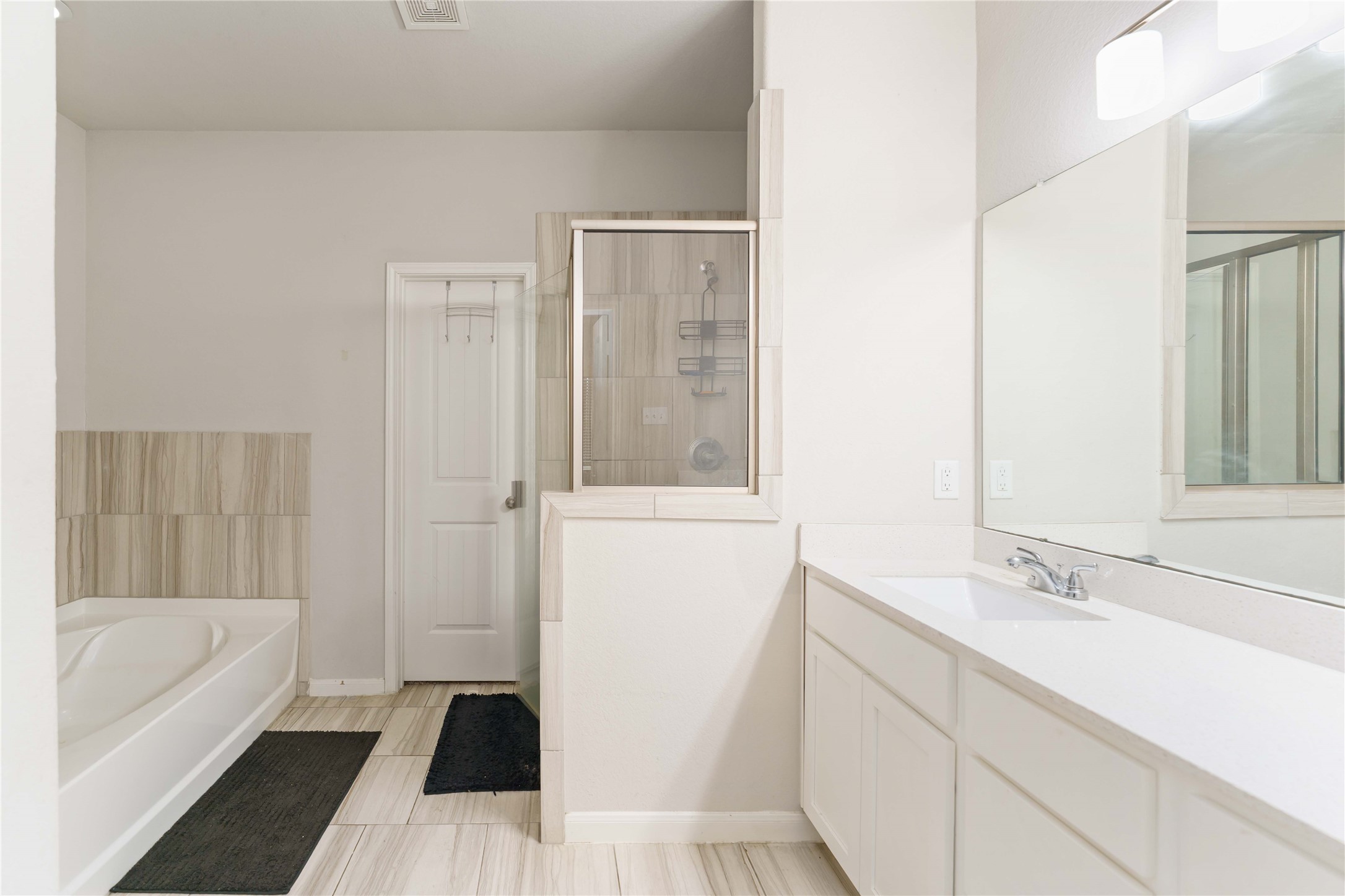 7002 Victorville Drive Rosharon, TX 77583 - Photo 12 of 27 a bathroom with a sink a bathtub and a shower
