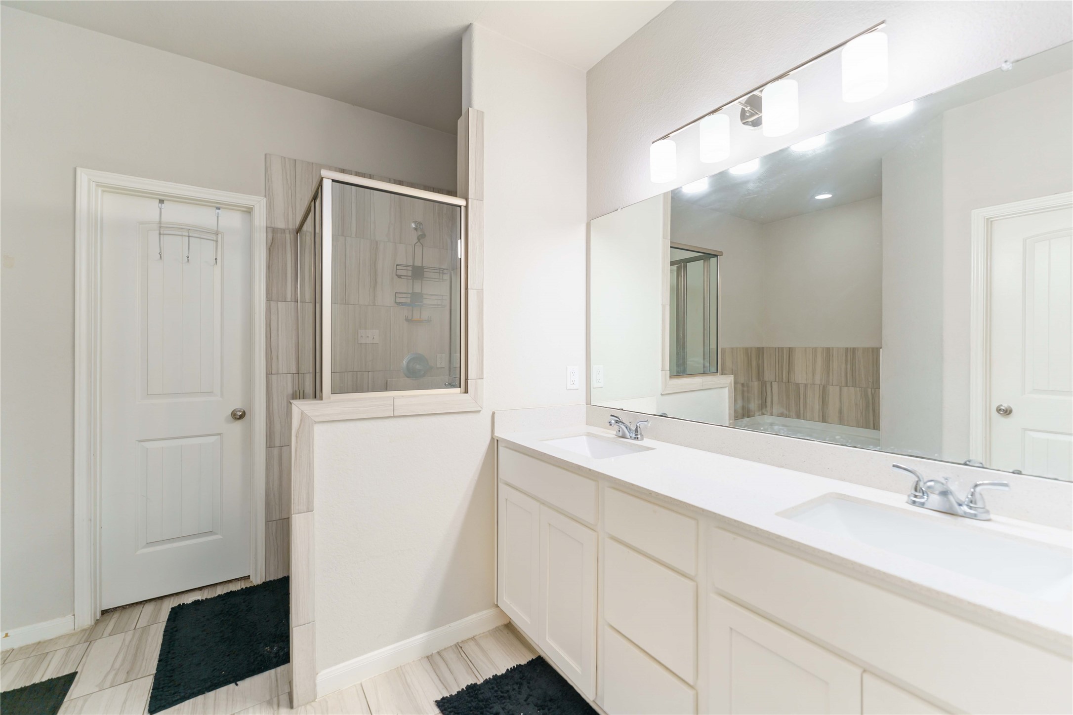 7002 Victorville Drive Rosharon, TX 77583 - Photo 13 of 27 a bathroom with a double vanity sink and mirror