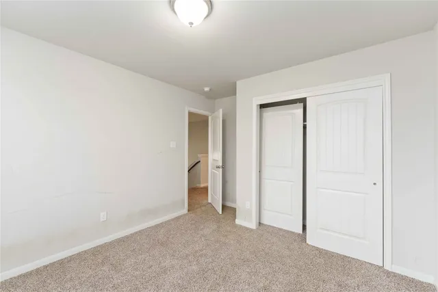 an empty room with closet area