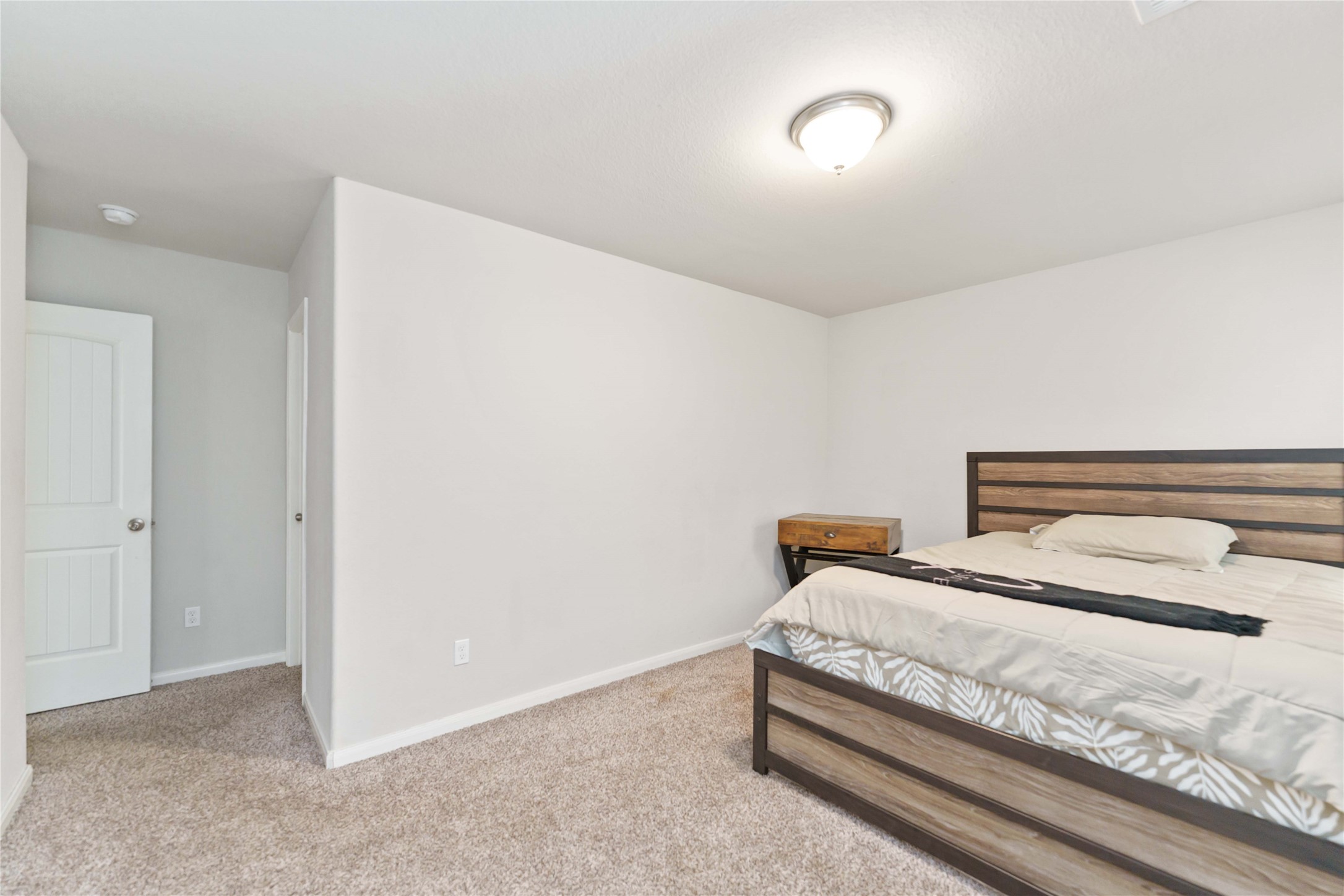 7002 Victorville Drive Rosharon, TX 77583 - Photo 20 of 27 a bedroom with a bed and a night stand
