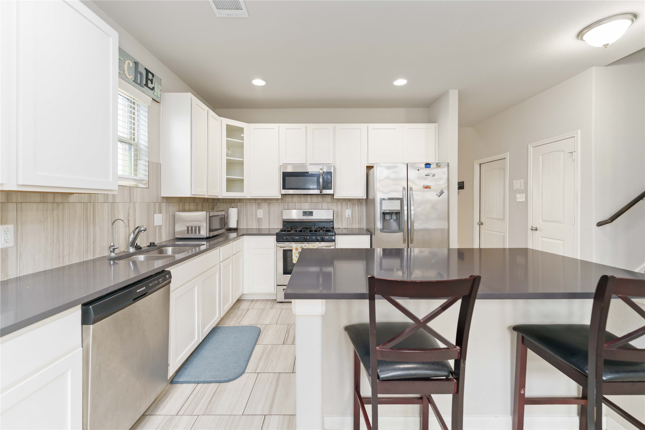 7002 Victorville Drive Rosharon, TX 77583 - Photo 5 of 27 a kitchen with a dining table chairs and refrigerator