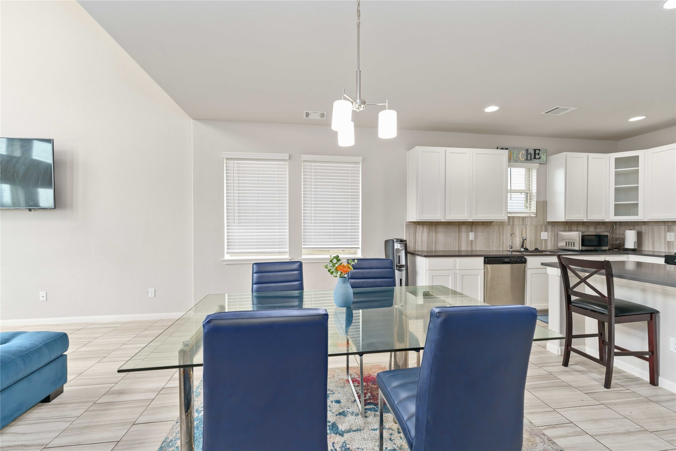 7002 Victorville Drive Rosharon, TX 77583 - Photo 7 of 27 a kitchen with stainless steel appliances granite countertop a stove top oven a sink dishwasher a dining table and chairs with wooden floor