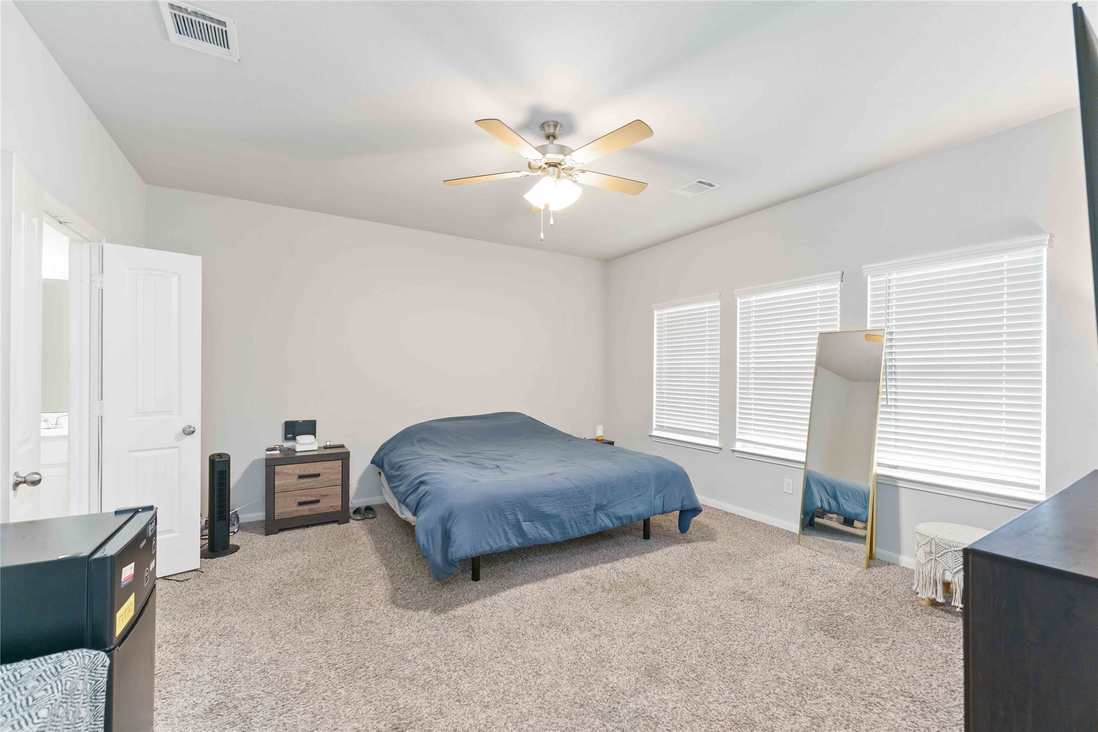 7002 Victorville Drive Rosharon, TX 77583 - Photo 10 of 27 a bedroom with a bed and a chandelier