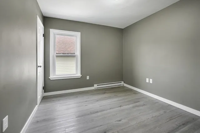 a kitchen with a refrigerator sink and wooden floor