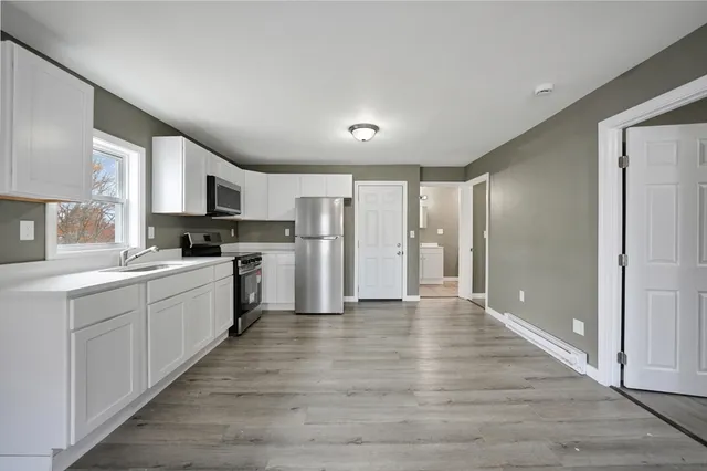 a view of a kitchen with a sink and a stove top oven