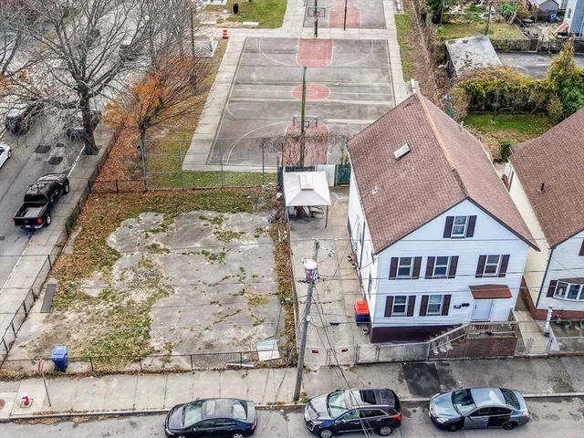 an aerial view of a house with a yard