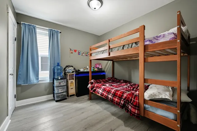 a kitchen with stainless steel appliances a refrigerator a stove a sink dishwasher and a dining table with wooden floor