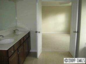 1037 Ridgehaven Road Waxhaw, NC 28173 - Photo 7 of 8 a bathroom with a sink a mirror and a shower