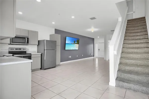 a spacious bedroom with a bed and window