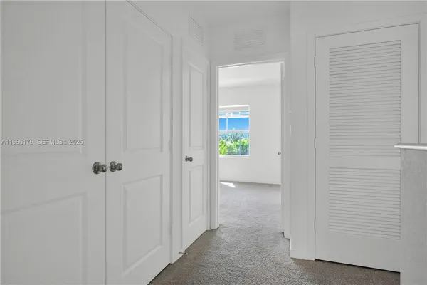an aerial view of a swimming pool with outdoor seating
