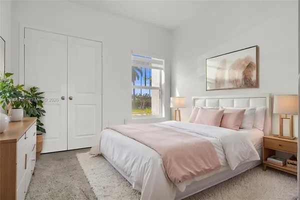 an aerial view of a swimming pool with outdoor seating