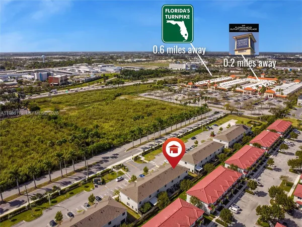 a living room with furniture a couch and paintings on wall