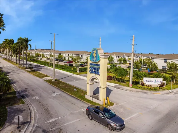 a view of a building with many windows and a table and chairs