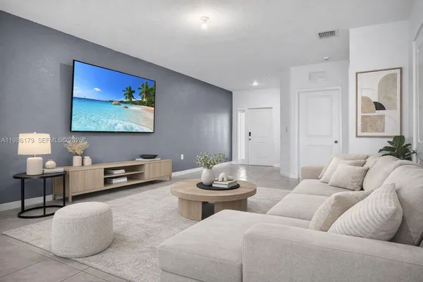 a kitchen with stainless steel appliances a dining table chairs refrigerator and a sink