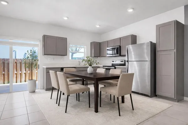 a view of kitchen with refrigerator and window