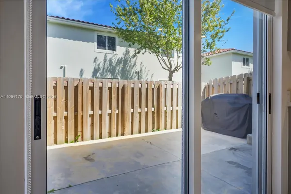a view of a kitchen with wooden floor and electronic appliances