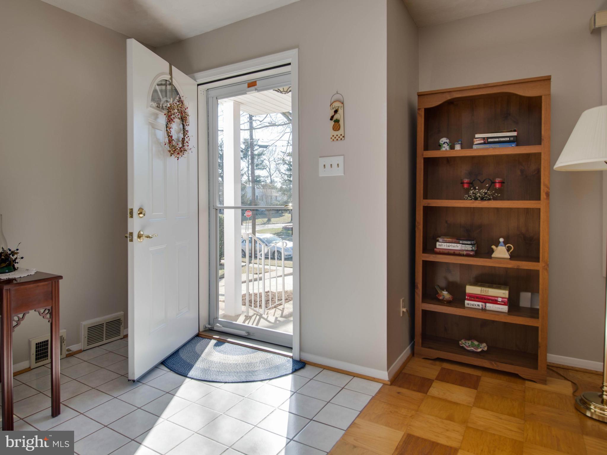 5223 Cather Road Springfield, VA 22151 - Photo 2 of 22 a view of an empty room with shelves and a window