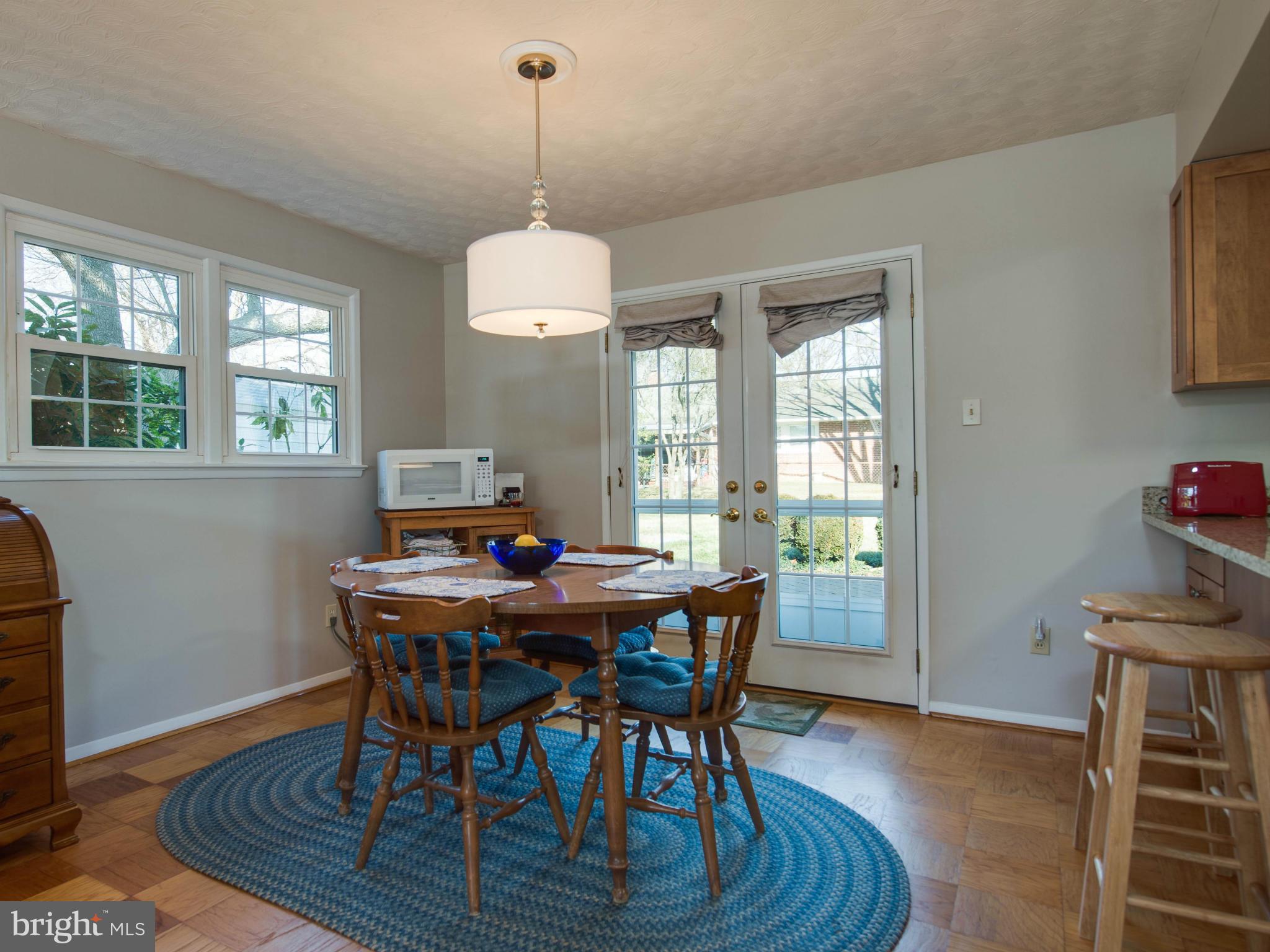 5223 Cather Road Springfield, VA 22151 - Photo 6 of 22 a view of a dining room with furniture window and wooden floor
