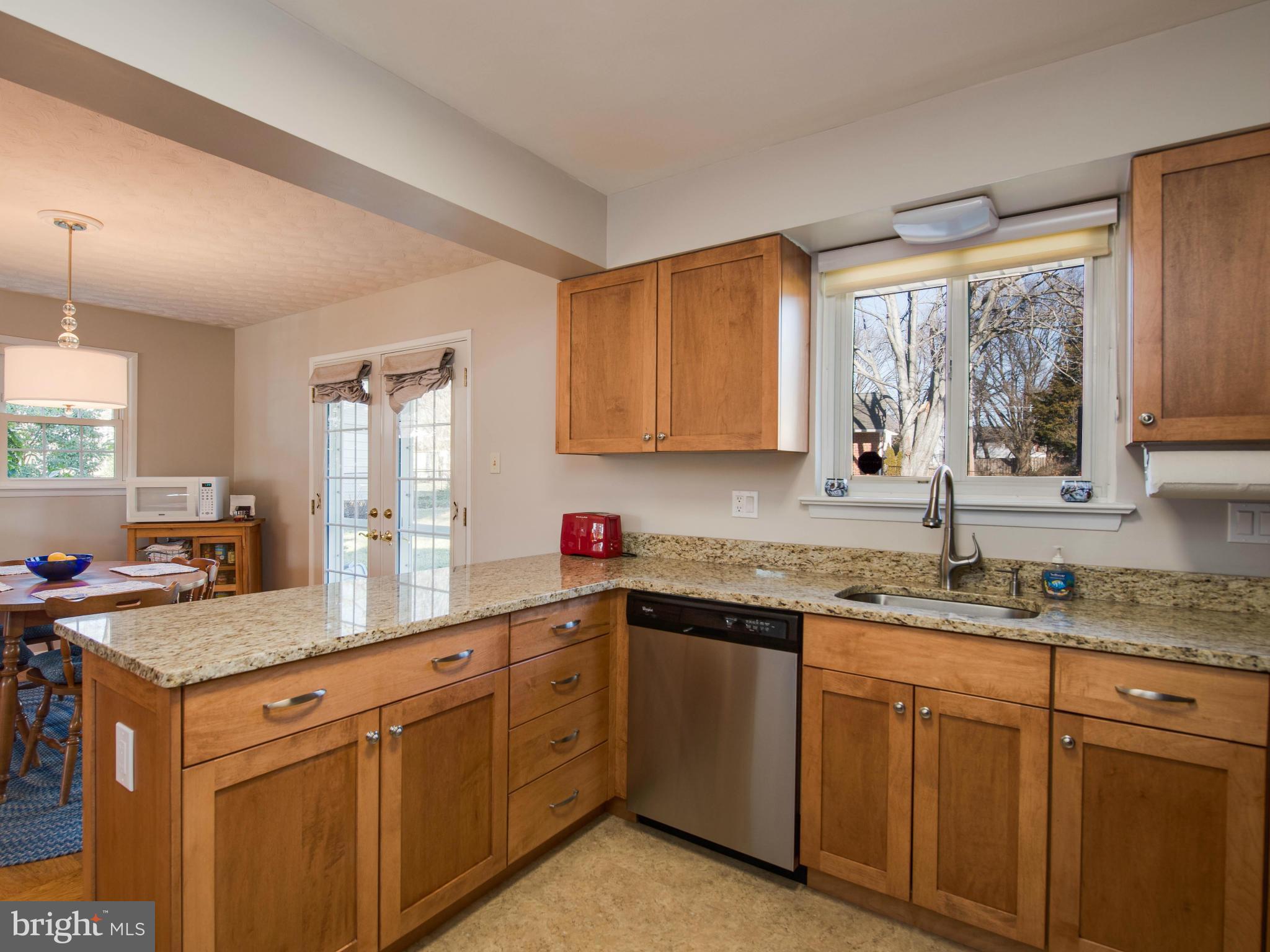 5223 Cather Road Springfield, VA 22151 - Photo 9 of 22 a kitchen with sink cabinets and window
