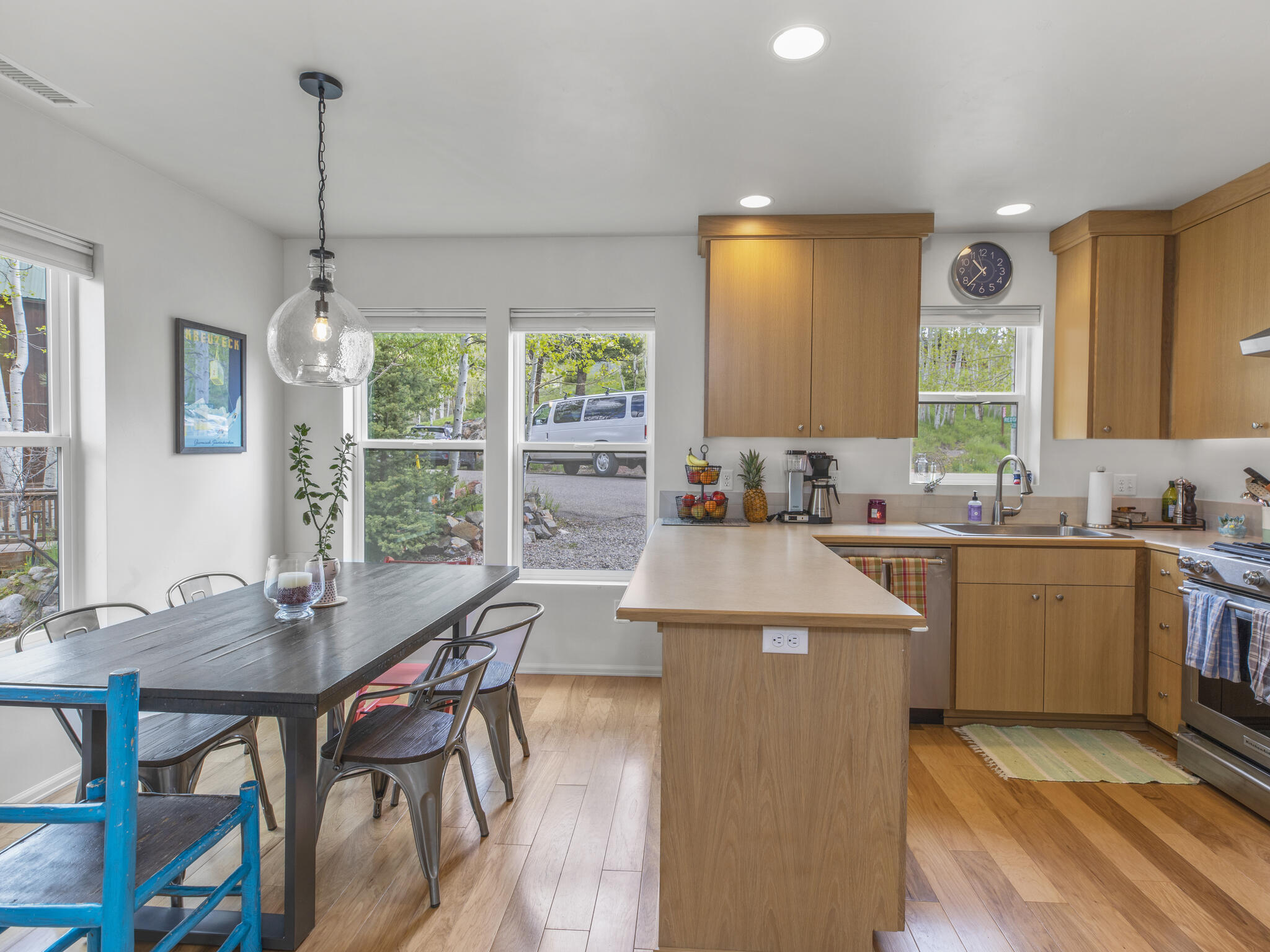 165 Alexander Overlook Telluride, CO 81435 - Photo 3 of 27 a kitchen with kitchen island stainless steel appliances a table and chairs in it
