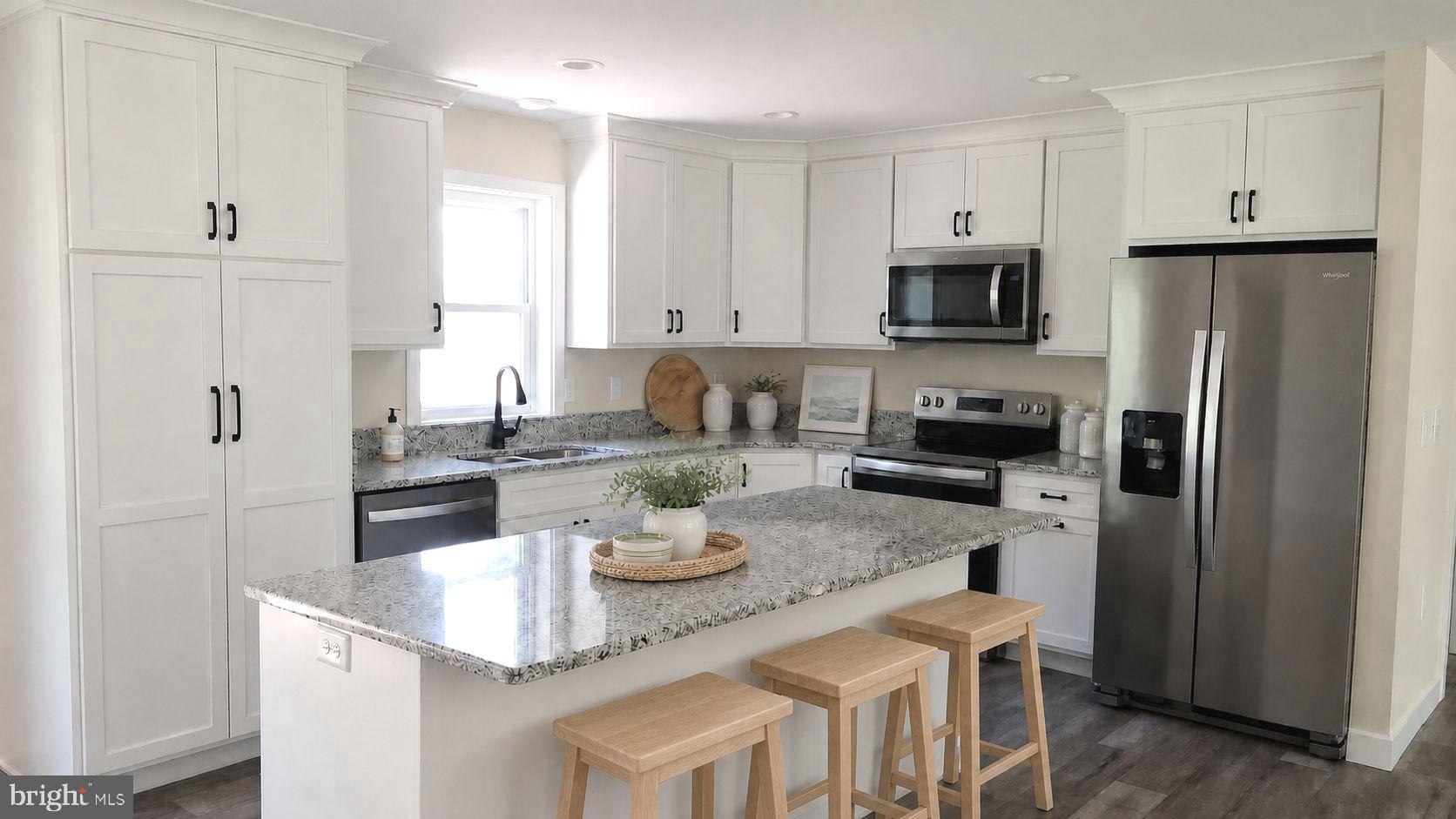 130 Soule Road New Bloomfield, PA 17068 - Photo 2 of 18 a kitchen with stainless steel appliances granite countertop a refrigerator a stove a sink dishwasher and white cabinets with wooden floor