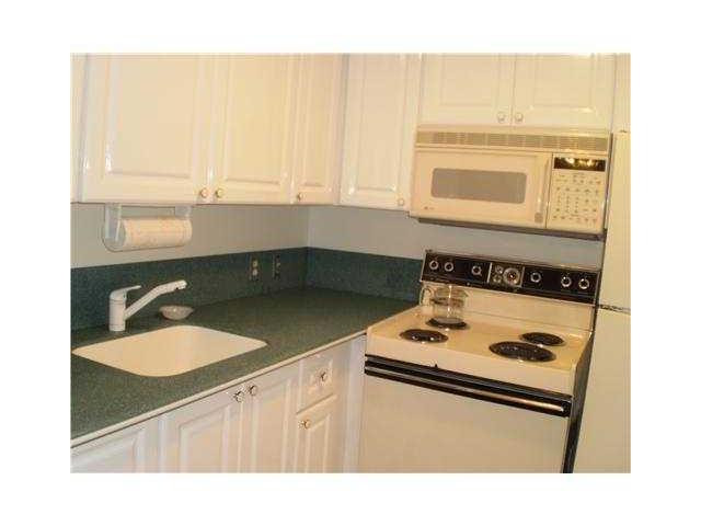 21 Suffolk A, Unit 21 Boca Raton, FL 33434 - Photo 2 of 7 a kitchen with a sink cabinets and window
