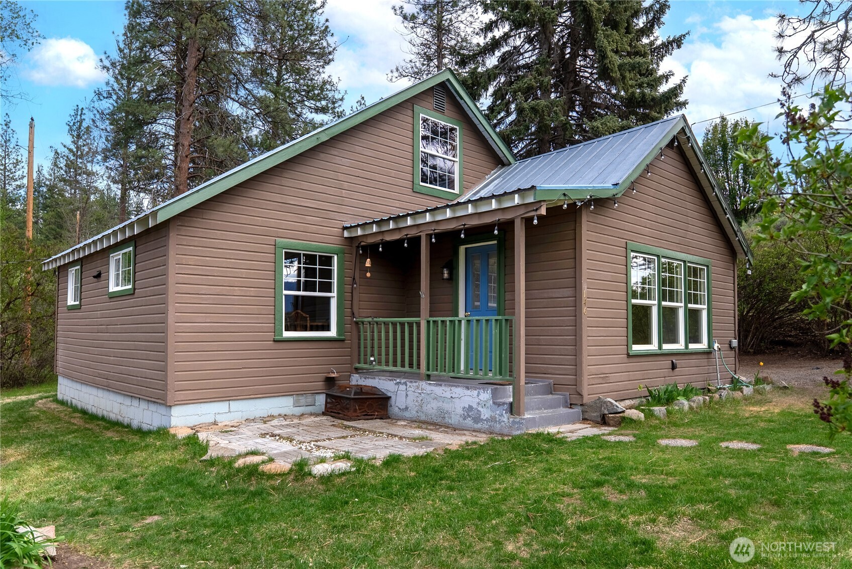146 East Chewuch Road Winthrop, WA 98862 - Photo 1 of 39 a front view of a house with a yard and porch