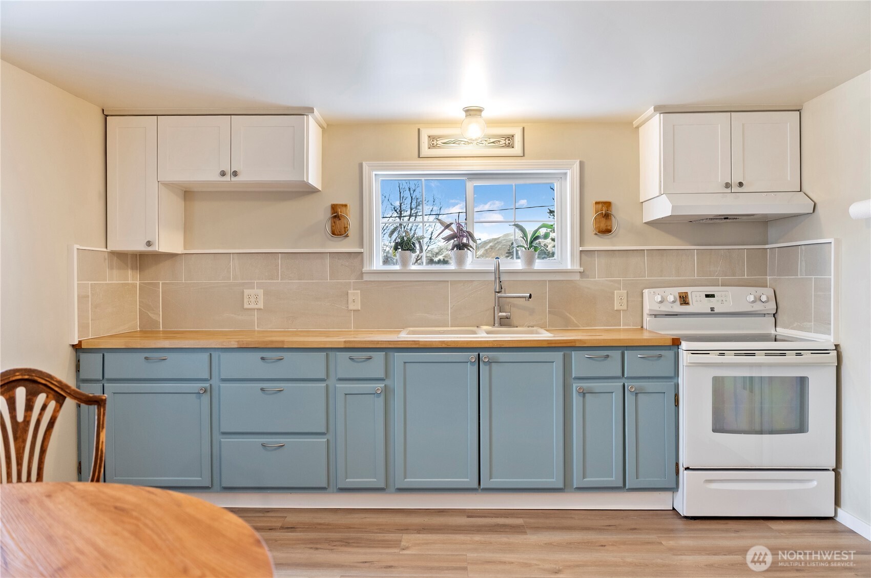 146 East Chewuch Road Winthrop, WA 98862 - Photo 18 of 39 a kitchen with stainless steel appliances granite countertop a sink and cabinets with wooden floor