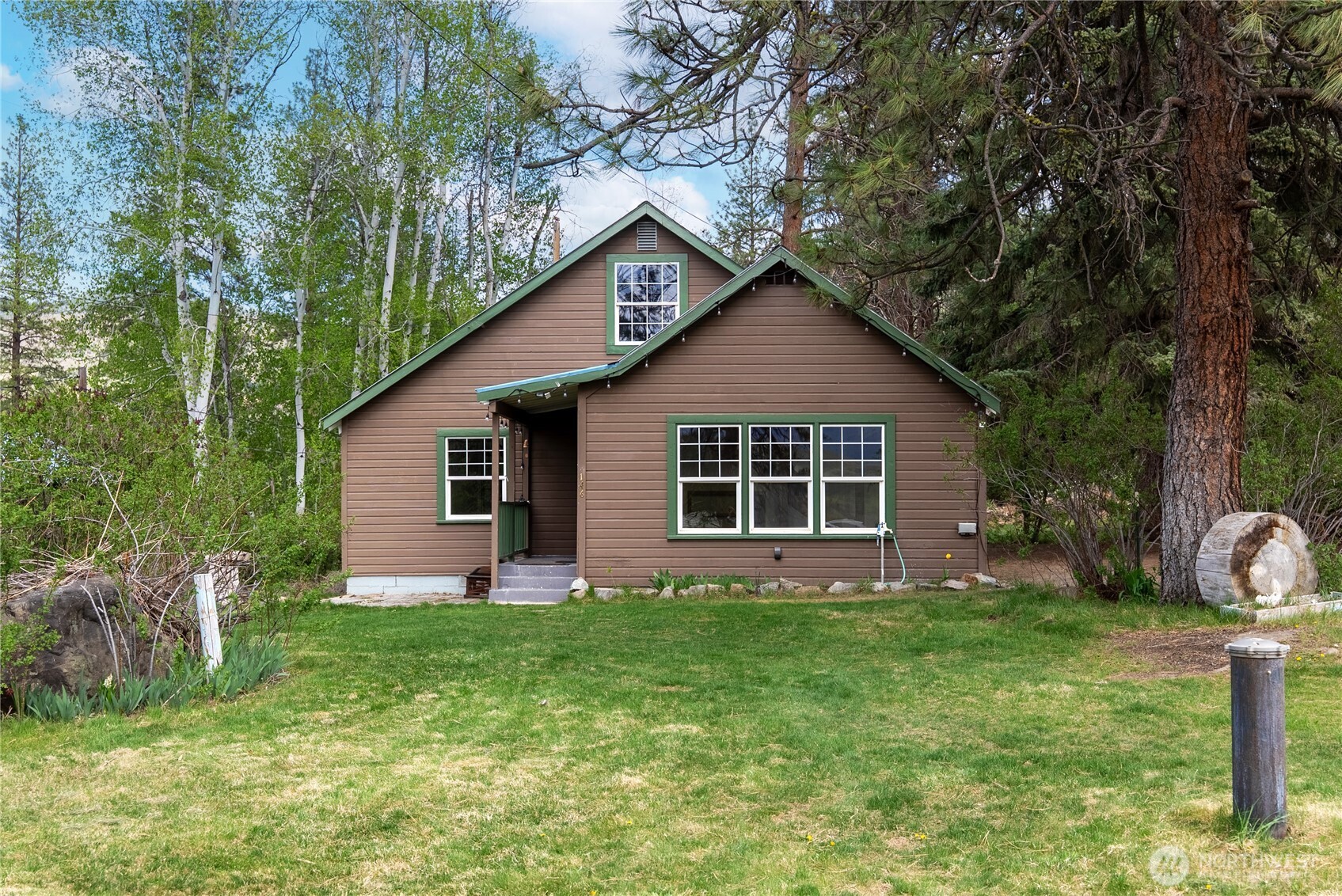 146 East Chewuch Road Winthrop, WA 98862 - Photo 2 of 39 a front view of house with yard and green space