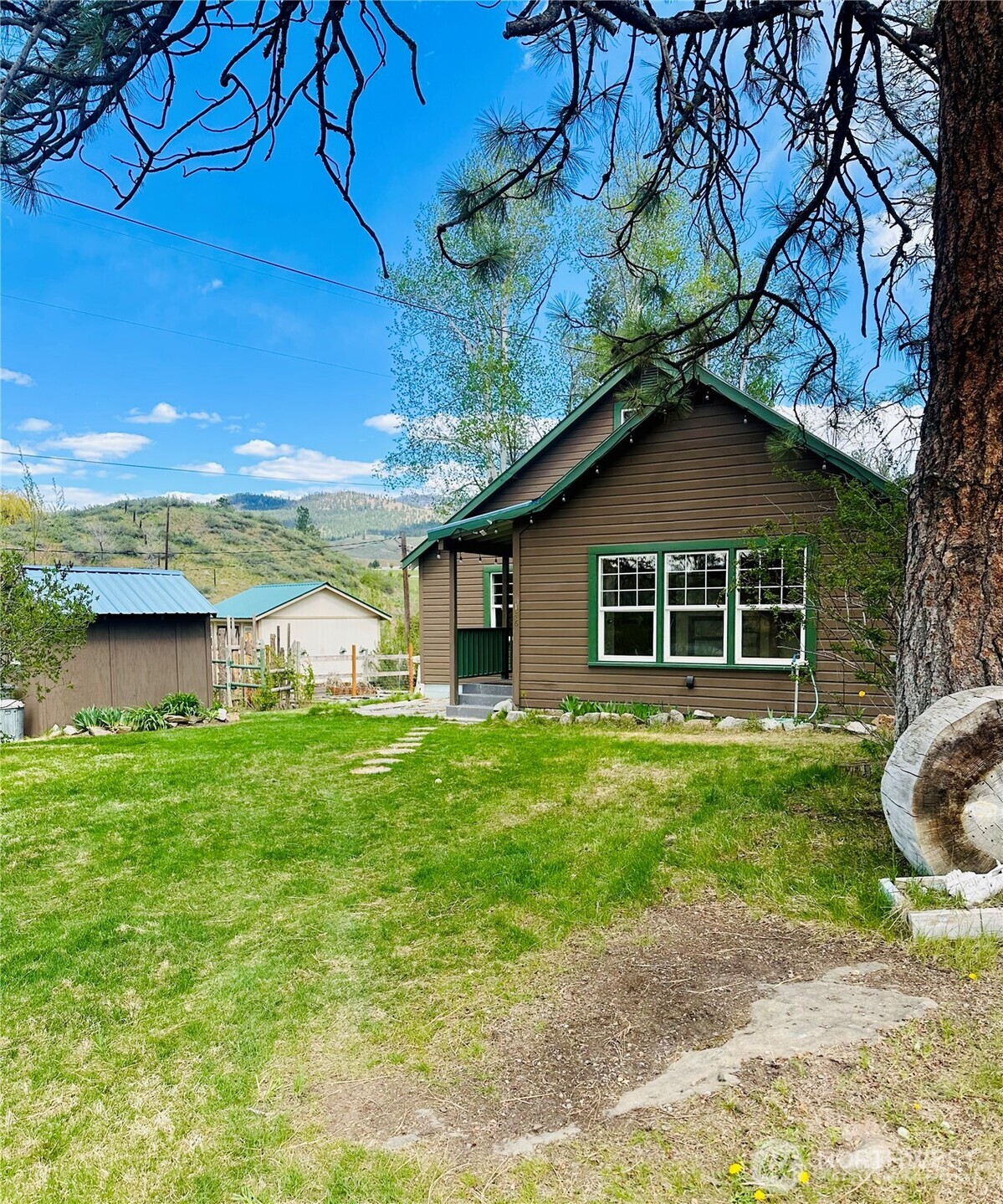 146 East Chewuch Road Winthrop, WA 98862 - Photo 3 of 39 a front view of a house with a garden