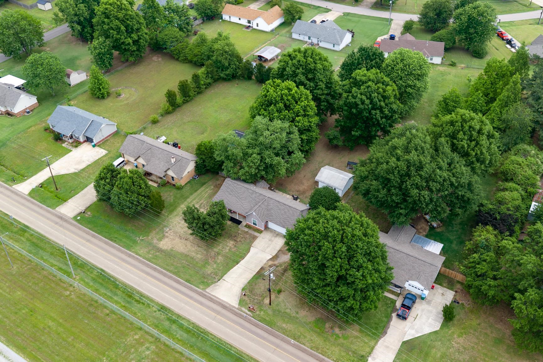 586 Beaver Road Munford, TN 38058 - Photo 20 of 21 Expansive property featuring a single-story residence with a concrete driveway and mature trees