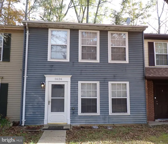 a view of a brick house with large windows