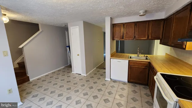 a kitchen with a stove refrigerator and cabinets
