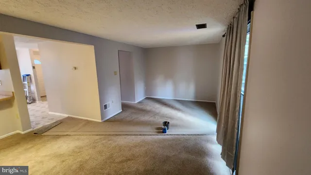 a view of a hallway with wooden floor and entryway
