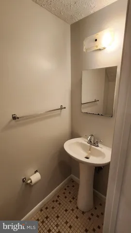 a white toilet sitting next to a shower