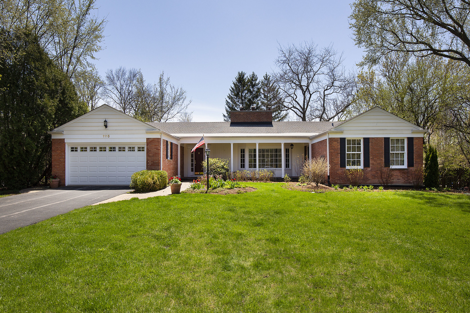 1115 West Deerpath Road Lake Forest, IL 60045 - Photo 1 of 18 a front view of a house with a garden and porch